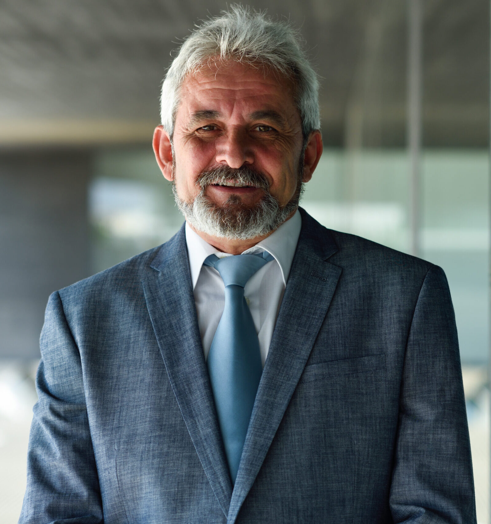 Senior businessman outside of modern office building.